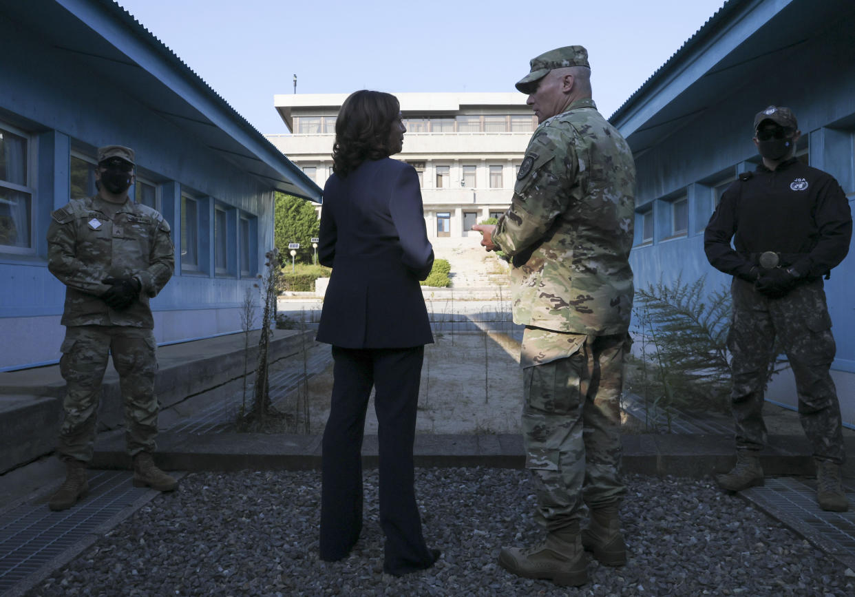 U.S. Vice President Kamala Harris, center left, stands next to the demarcation line at the demilitarized zone (DMZ) separating the two Koreas, in Panmunjom, South Korea Thursday, Sept. 29, 2022. (Leah Millis/Pool Photo via AP)