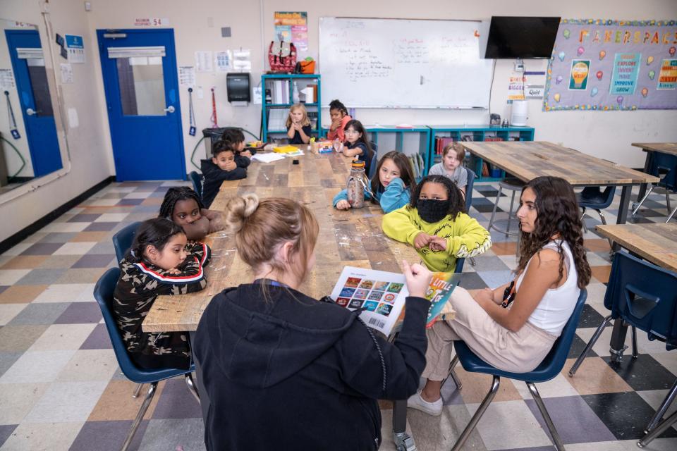 Ariana Ruof, a wellness coach with Terros Health, leads a reading activity during an after school program at the Boys & Girls Clubs of the Valley Grant Woods Branch in Mesa on November 14, 2023.