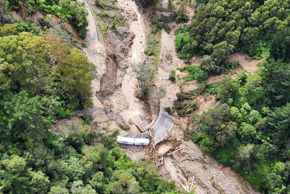 A road between Napier and Wairoa in New Zealand is washed out by floodwater following Cyclone Gabrielle (AP)