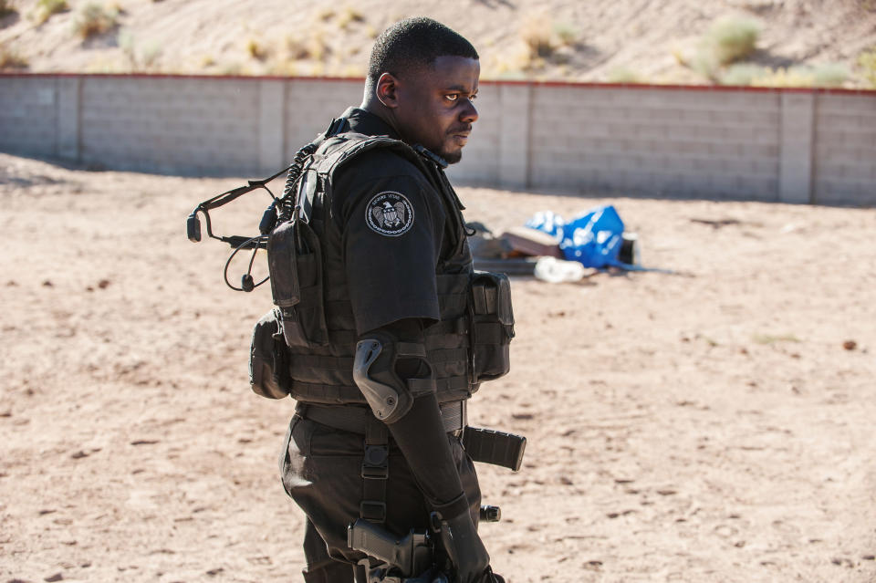 Daniel Kaluuya in tactical gear on a desert-like set for a film scene