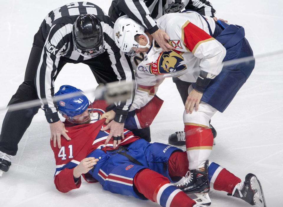 Florida Panthers defenseman MacKenzie Weegar (52) knocks out Montreal Canadiens left wing Paul Byron (41) during the first period of an NHL hockey game Tuesday, March 26, 2019, in Montreal. (Ryan Remiorz/The Canadian Press via AP)