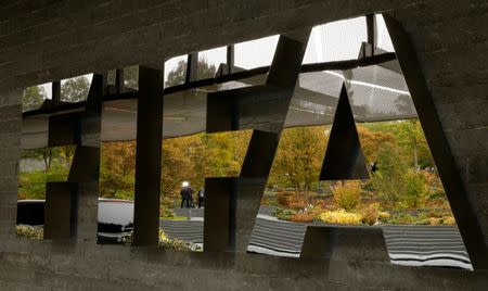 A TV team is reflected in a logo of FIFA a meeting of the FIFA Council at its headquarters in Zurich, Switzerland October 13, 2016. REUTERS/Arnd Wiegmann