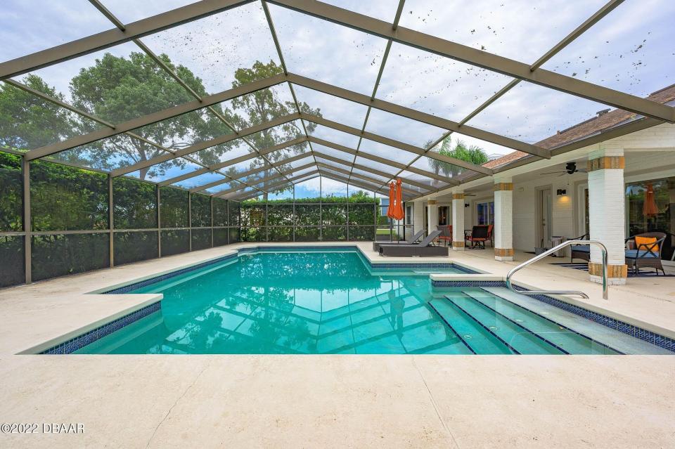The large screened in-ground heated pool is a great place to lounge.
