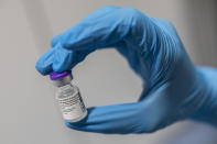 A nurse holds a bottle of the Pfizer-BioNTech COVID-19 vaccine at the Nurse Isabel Zendal Hospital in Madrid, Spain, Monday, Feb. 1, 2021. (AP Photo/Bernat Armangue)