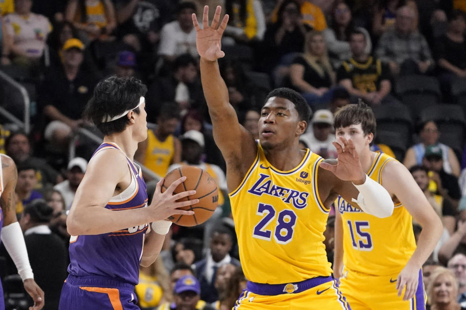 Los Angeles Lakers forward Rui Hachimura, right, guards Phoenix Suns forward Yuta Watanabe during the first half of an NBA preseason basketball game Thursday, Oct. 19, 2023, in Thousand Palms, Calif. (AP Photo/Mark J. Terrill)