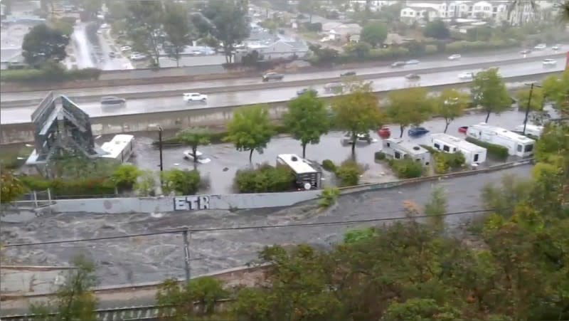 Vehicles are seen floating away amid flash flooding in San Diego