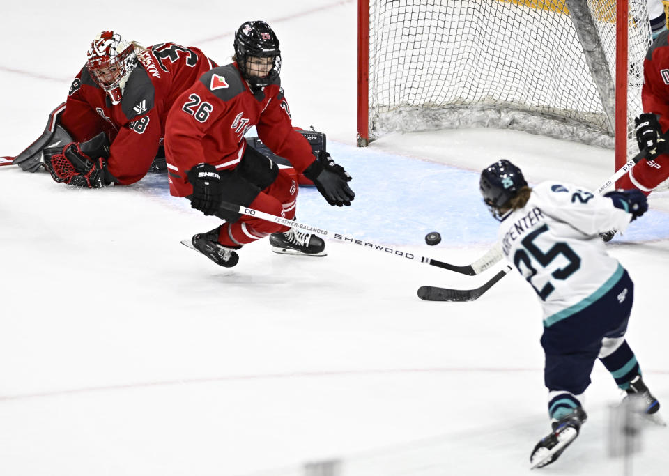 Ottawa's Emerance Maschmeyer (38) watches as Ottawa's Emily Clark (26) is unable to defend against a shot by New York's Alex Carpenter (25) who scores to tie a PWHL hockey game in the third period in Ottawa, Ontario, Sunday, Feb. 4, 2024. (Justin Tang/The Canadian Press via AP)