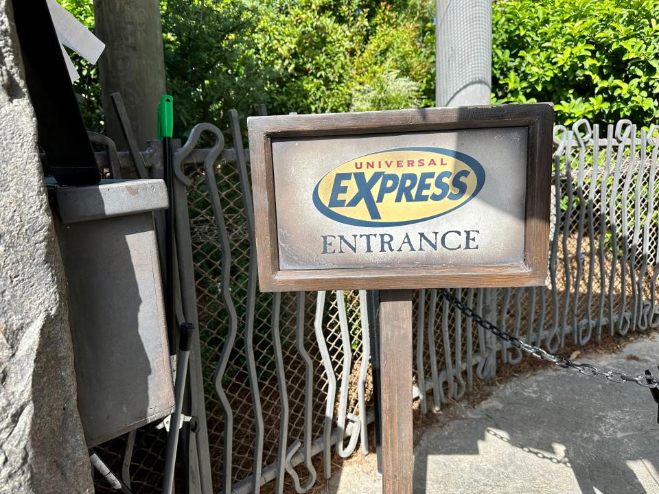 sign for a universal express pass in front of a ride at universal orlando