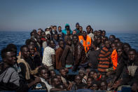 <p>Refugees and migrants wait to be rescued from a small wooden boat by crew members from the Migrant Offshore Aid Station Phoenix vessel on May 18, 2017, off Lampedusa, Italy. (Photo: Chris McGrath/Getty Images) </p>