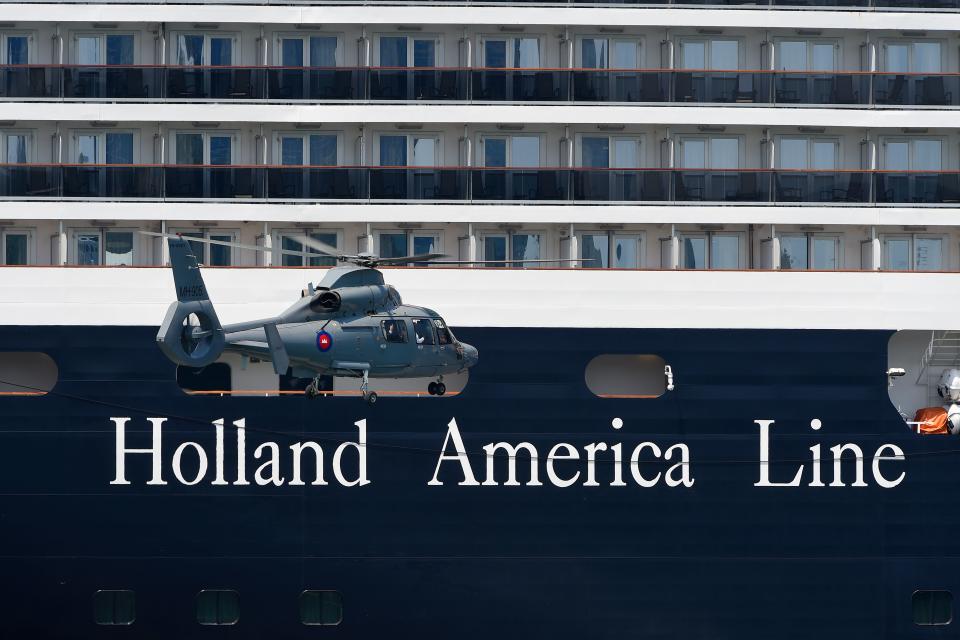 A helicopter approaches the Westerdam cruise ship