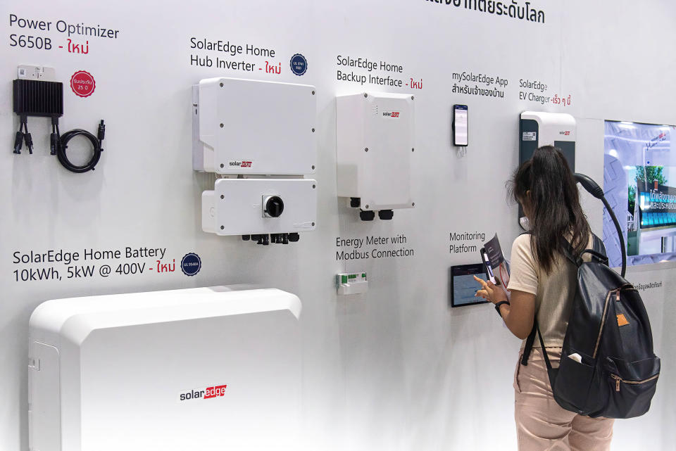 BANGKOK, THAILAND - 2023/09/01: A visitor inspects products at the SolarEdge booth during the event at The Queen Sirikit National Convention Center. The ASEAN Sustainable Energy Week 2023 is the renewable energy innovation and environment technologies showcase convening international innovators, investors, technology experts and firms from all sectors to exhibit their latest technologies of the smart energy solutions, clean energy vehicles. (Photo by Peerapon Boonyakiat/SOPA Images/LightRocket via Getty Images)