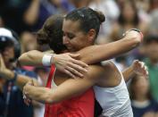 Flavia Pennetta of Italy (R) hugs compatriot Roberta Vinci after Pennetta won their women's singles finals match at the U.S. Open Championships tennis tournament in New York, September 12, 2015. REUTERS/Mike Segar