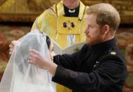 <p>Traditionally the purview of the father of the bride, the newly-minted Duke of Sussex took on the role of removing his bride's veil... <a href="https://www.townandcountrymag.com/the-scene/weddings/a20755882/prince-harry-face-royal-wedding-meghan-markle-veil/" rel="nofollow noopener" target="_blank" data-ylk="slk:and fumbled it just a little;elm:context_link;itc:0;sec:content-canvas" class="link ">and fumbled it just a little</a>. The moment served as an endearing reminder that as carefully choreographed as the royal wedding might have been, in the end it was all about the love between one real couple. </p>