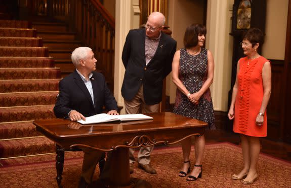 SYDNEY, AUSTRALIA - APRIL 23: U.S. Vice President Mike Pence (L) signs the visitors book at Government House with the Governor of New South Wales David Hurley (2nd-L) and their wives Karen (2nd-R) and Linda (R) on April 23, 2017 in Sydney, Australia. Pence is visiting Australia on a three-day official tour during which he is holding talks with high officials on bilateral and international issues. (Photo by Peter Parks-Pool/Getty Images)