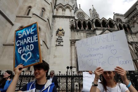 FILE PHOTO: People campaign to show support for allowing Charlie Gard to travel to the United Stated to receive further treatment, outside the High Court in London, Britain July 13, 2017. REUTERS/Peter Nicholls