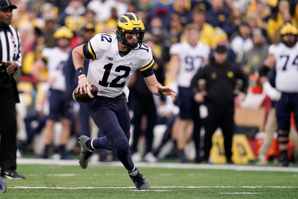 Michigan quarterback Cade McNamara scrambles against Maryland during the first half Saturday, Nov. 20, 2021.