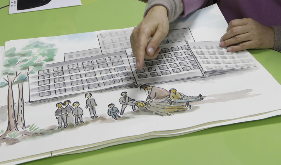 In this Dec. 21, 2018, photo, North Korean defector Kwak Jeong-ae, 65, shows a drawing about North Korea during an interview in Uijeongbu, South Korea. Experts and defectors say most of North Korea’s underground Christians do not engage in the extremely dangerous work of proselytizing. Instead, they largely keep their beliefs to themselves or within their immediate families. (AP Photo/Lee Jin-man)