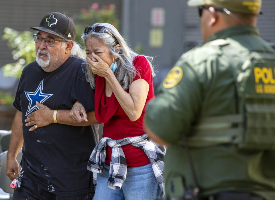 FILE - A woman cries as she leaves the Uvalde Civic Center, May 24, 2022, in Uvalde, Texas. Since the start of 2020, researchers at the Naval Postgraduate School have recorded 504 cases of gun violence at schools — a number that eclipses the previous eight years combined. (William Luther/The San Antonio Express-News via AP, File)