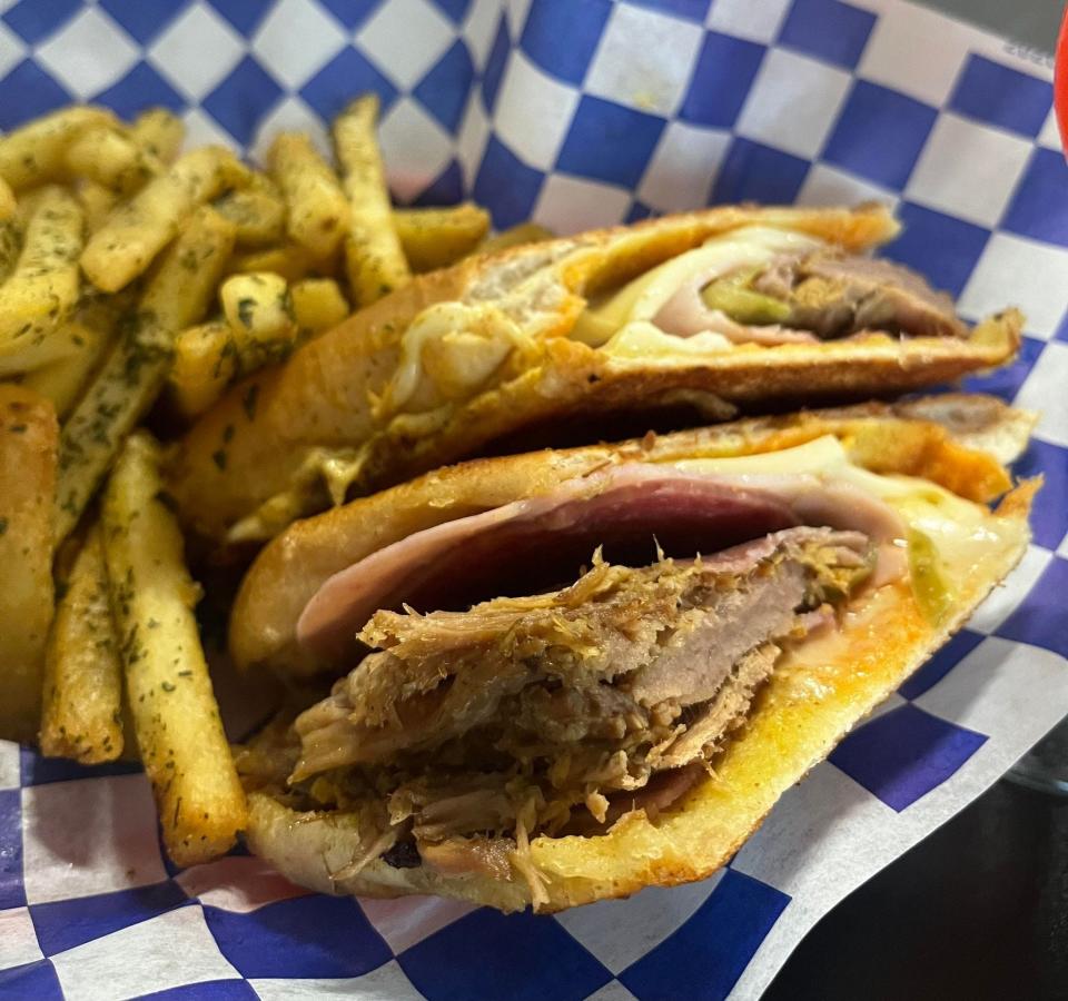 Meet the Cubano at Pensacola's Joe's Caribe. The $15 sandwich showcases a slow-roasted and seasoned pork shoulder, ham, salami, swiss cheese and mustard, served with a side of seasoned fries.