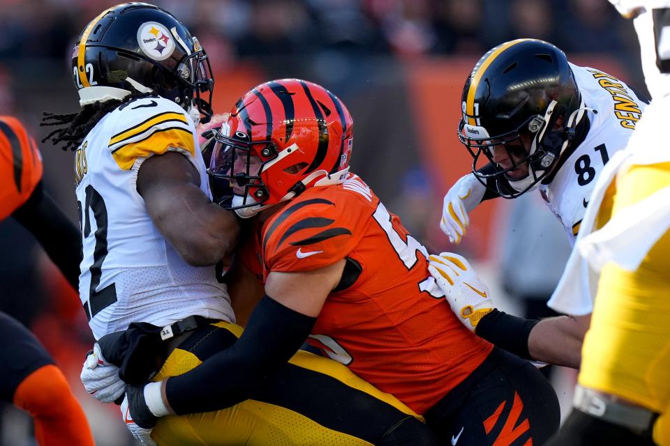 Cincinnati Bengals linebacker Logan Wilson (55) tackled Pittsburgh Steelers running back Najee Harris (22) in the second quarter during a Week 12 NFL football game, Sunday, Nov. 28, 2021, at Paul Brown Stadium in Cincinnati. 