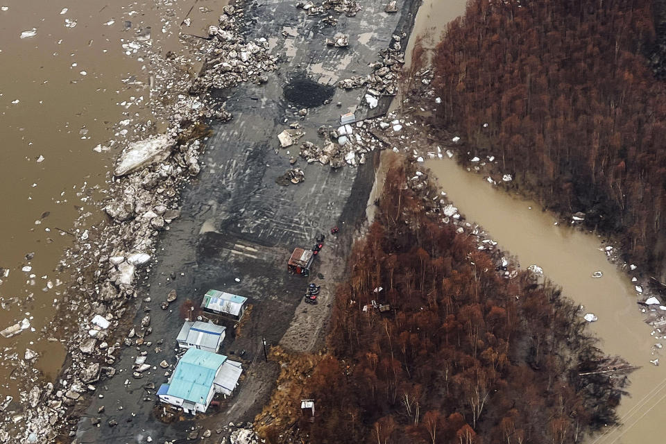 In this aerial view, chunks of ice follow flooding from an ice jam in Crooked Creek, Alaska, May 15, 2023. Ice jams along two Alaska rivers unleashed major flooding over the weekend. (Jennifer Wallace, Alaska Division of Homeland Security and Emergency Management via AP)