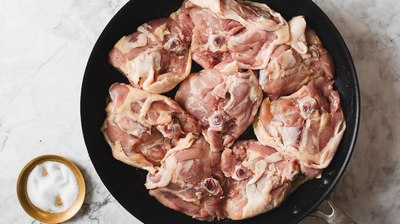 Raw chicken in pan