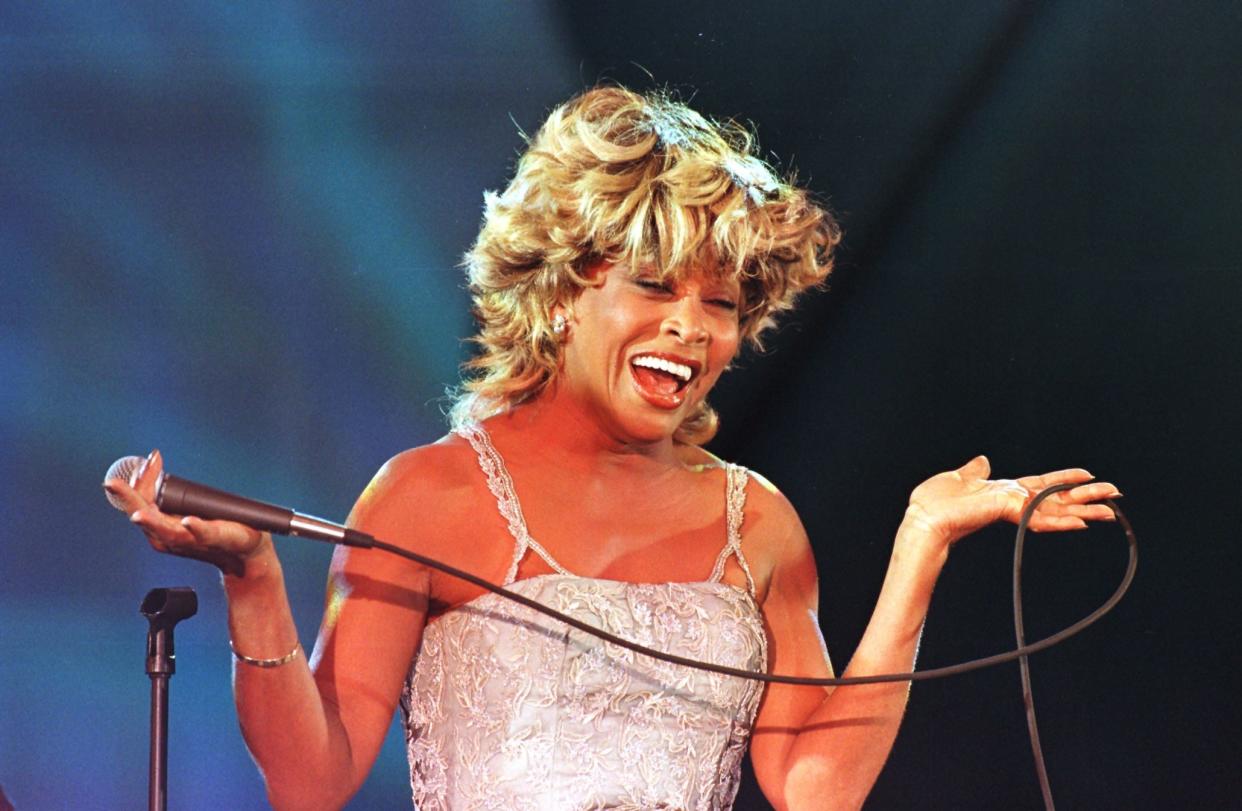 Tina Turner sings during her performance at the Macy’s Passport ‘97 fund raiser. (AFP via Getty Images)
