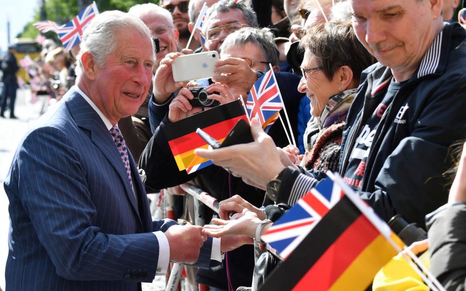 The King greets crowds during a visit to Brandenburg Gate, in Berlin, in 2019, when he was Prince of Wales - John Macdougall/AFP via Getty Images