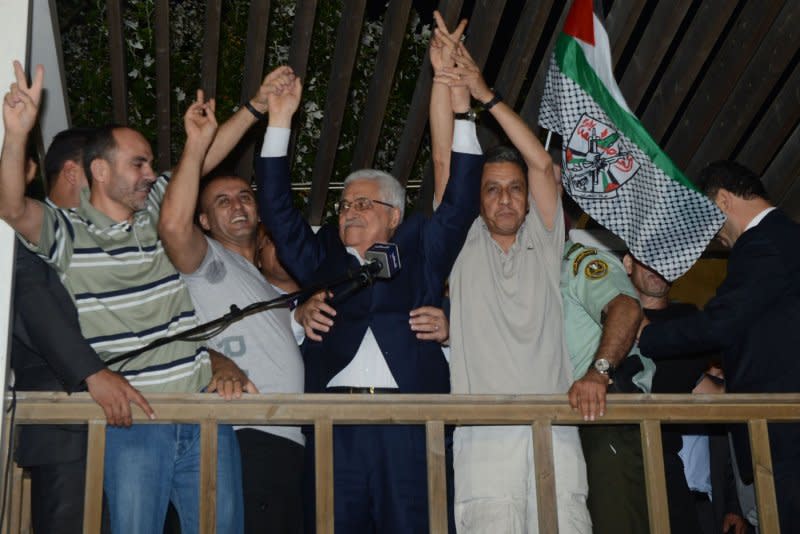 Palestinian Authority President Mahmoud Abbas welcomes prisoners released from Israeli prison in the West Bank town of Ramallah early August 14, 2013. File Photo by Thaer Ghanaim/UPI