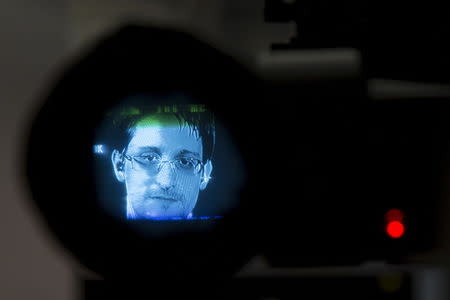 American whistleblower Edward Snowden is seen through a camera viewfinder as he delivers remarks via video link from Moscow to attendees at a discussion regarding an International Treaty on the Right to Privacy, Protection Against Improper Surveillance and Protection of Whistleblowers in Manhattan, New York September 24, 2015. REUTERS/Andrew Kelly