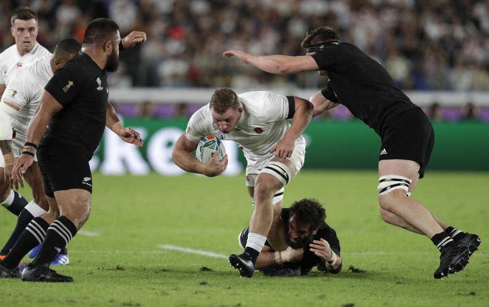 England's Sam Underhill runs at the All Blacks defence during the Rugby World Cup semifinal at International Yokohama Stadium between New Zealand and England in Yokohama, Japan, Saturday, Oct. 26, 2019. (AP Photo/Mark Baker)