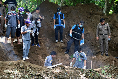 Thai Police and workers recover the bodies of a British citizen Alan Hogg, a 64-year-old retired businessman and his Thai wife Nod Suddaen, 61, buried near a creek on their property in the country's north province of Phrae, Thailand September 25, 2018. Dailynews/Handout via REUTERS