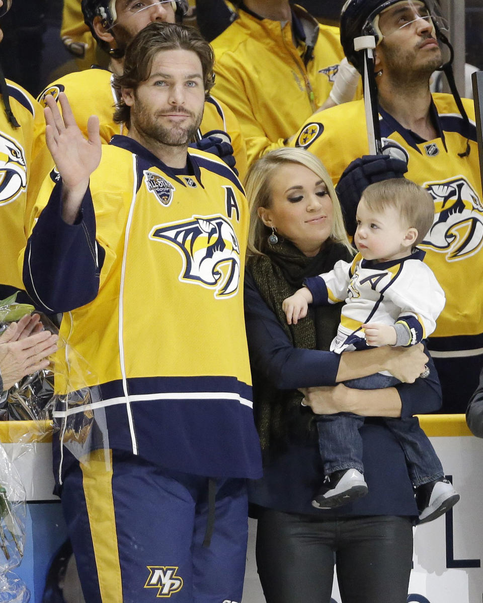 Mike Fisher with Carrie Underwood and son Isaiah (Mark Humphrey / AP)