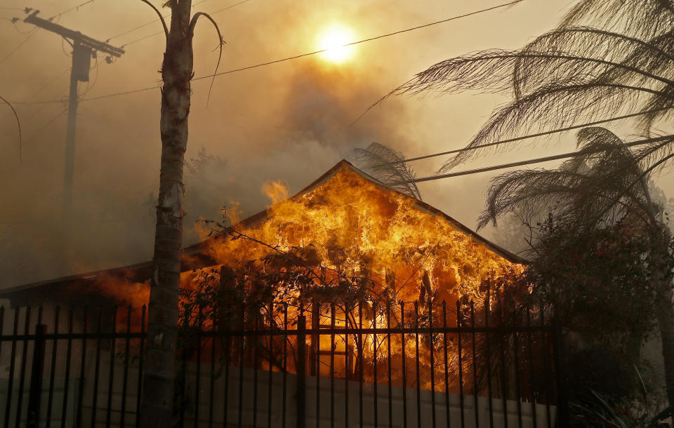 A structure is fully engulfed by flames in Shadow Hills.