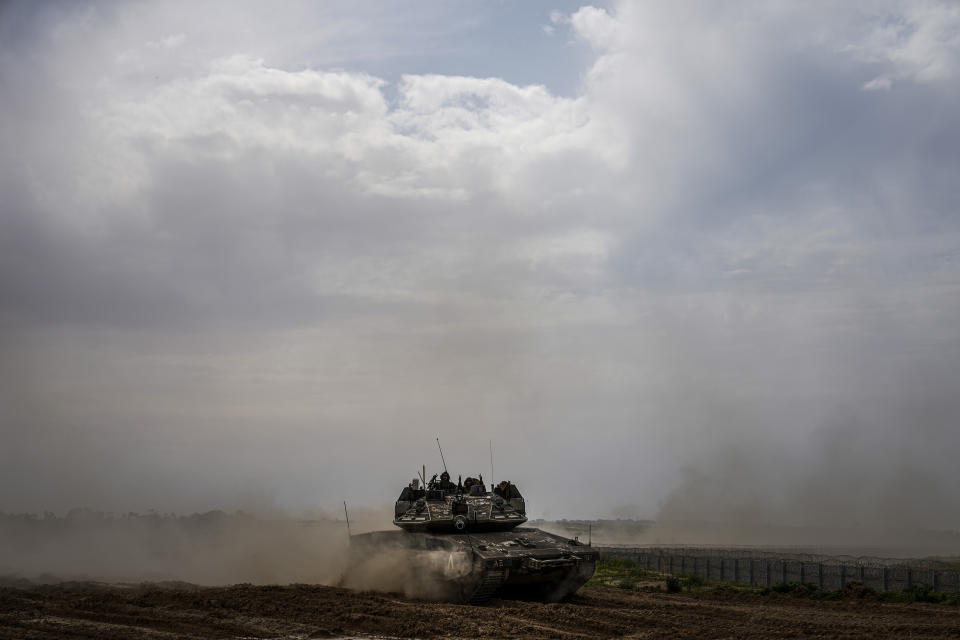 Israeli soldiers drive a tank on the border with the Gaza Strip, in southern Israel, Tuesday, Feb. 13, 2024. The army is battling Palestinian militants across Gaza in the war ignited by Hamas' Oct. 7 attack into Israel. (AP Photo/Ariel Schalit)