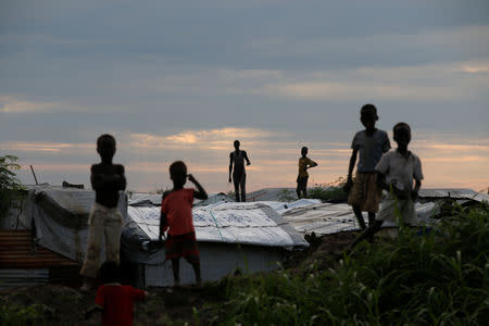 Internally displaced people (IDPs) stand on roofs in the Protection of Civilians (POC) Camp, run by the UN Mission in South Sudan near the town of Malakal, in the Upper Nile state of South Sudan, September 8, 2018. REUTERS/Baz Ratner