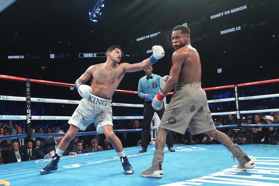 Ryan Garcia, left, punches Devin Haney during the 12th round of a super lightweight boxing match Sunday, April 21, 2024, in New York. (AP Photo/Frank Franklin II)