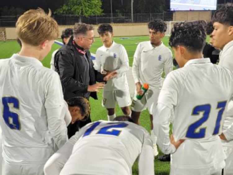 San Elizario coach Max Sappenfield talks to his team prior to its state semifinal against Navasota Wednesday night in Georgetown