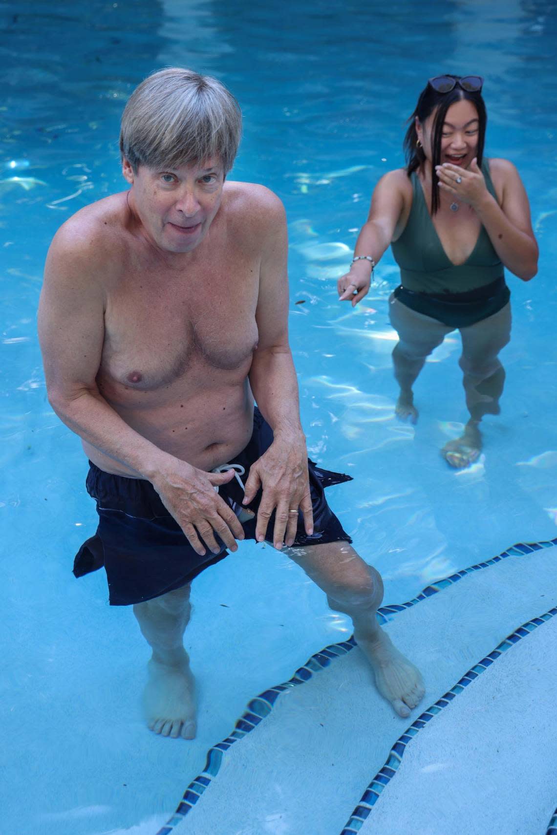 Dave Barry models the Dissolving Swimsuit from the Dave Barry 2022 Holiday Gift Guide while Sydney Walsh, a Miami Herald photographer, reacts on Wednesday, Nov. 23, 2022, in Coral Gables, Florida.