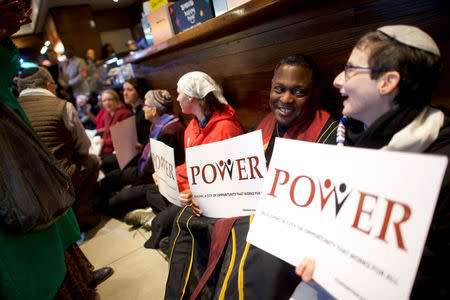 Rev. Gregory Holston, 56, (2nd R) and other Interfaith clergy leaders stage a sit-in at the Center City Starbucks, where two black men were arrested, in Philadelphia, Pennsylvania U.S. April 16, 2018. REUTERS/Mark Makela