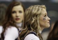 A Gonzaga cheerleader wears a bulldog decal during the first half in a second-round game in the NCAA college basketball tournament Friday, March 21, 2014, in San Diego. (AP Photo/Gregory Bull)