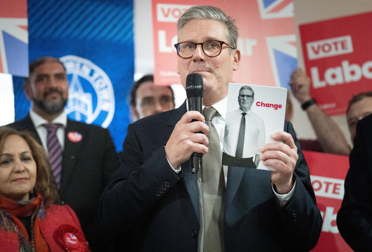 Labour Party leader Sir Keir Starmer holds a copy of his party’s election manifesto whilst campaigning in Halesowen in the West Midlands for this year’s General Election on July 4. Picture date: Thursday June 13, 2024.