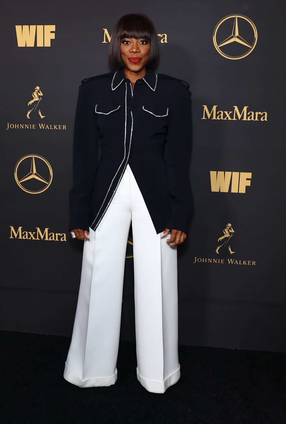 Yvonne Orji wearing white pants. 