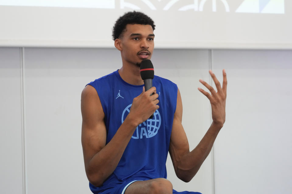 France's basketball player Victor Wembanyama, who plays for the NBA San Antonio Spurs, gestures while speaking during media day at the French National Institute of Sport and Physical Education, in Vincennes, outside Paris, Thursday, June 27, 2024. (AP Photo/Thibault Camus)