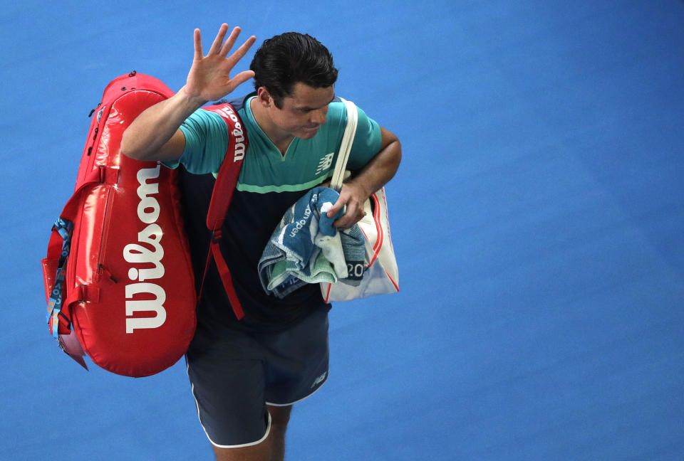 Canada's Milos Raonic waves as he leaves Rod Laver Arena following his quarterfinal loss to France's Lucas Pouille at the Australian Open tennis championships in Melbourne, Australia, Wednesday, Jan. 23, 2019. (AP Photo/Kin Cheung)