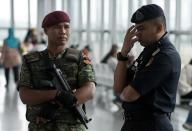 Malaysian military and police stand guard at Kuala Lumpur International Airport on March 16, 2014