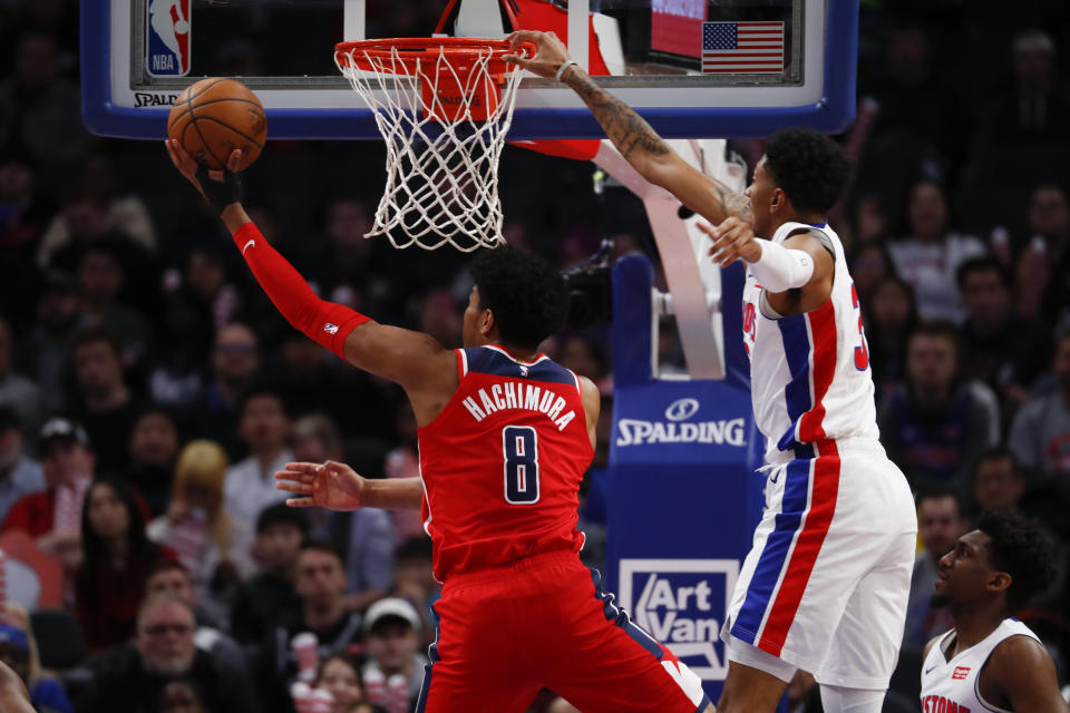 Washington Wizards forward Rui Hachimura (8) drives on Detroit Pistons forward Christian Wood (35) in the first half of an NBA basketball game in Detroit, Monday, Dec. 16, 2019. (AP Photo/Paul Sancya)