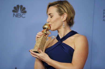 Actress Kate Winslet poses with her award for Best Performance by an Actress in a Supporting Role in any Motion Picture for her role in "Steve Jobs," backstage at the 73rd Golden Globe Awards in Beverly Hills, California January 10, 2016. REUTERS/Lucy Nicholson