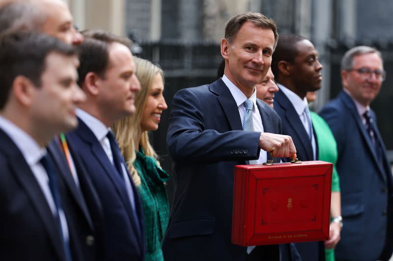 British Chancellor of the Exchequer Jeremy Hunt holds the budget box on Downing Street in London