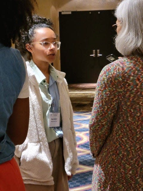 Maya Wallach, then 16, a Michigan State University physics student, speaks with Allena Opper, National Science Foundation program director for experimental nuclear physics, during an October 2022 conference of the American Physical Society's Division of Nuclear Physics in New Orleans.